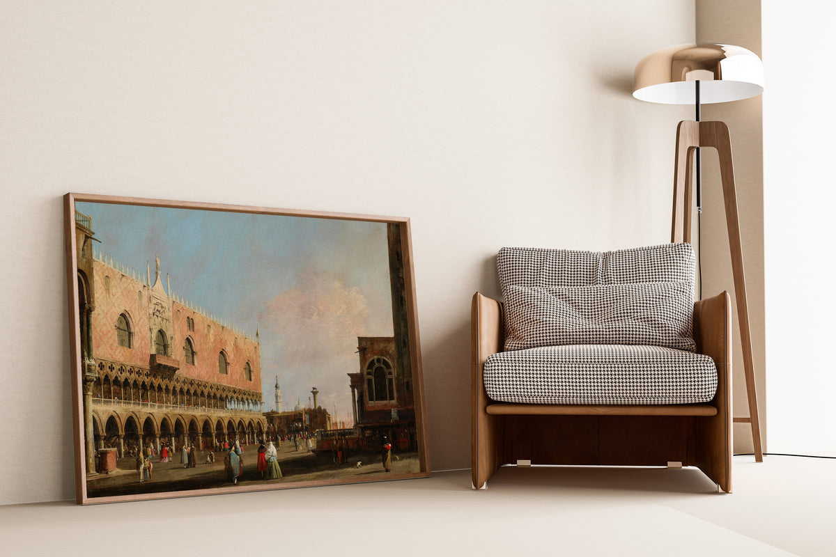 Framed art print of View of the Piazzetta San Marco Looking South by Canaletto, leaning against a wall beside an armchair and a floor lamp