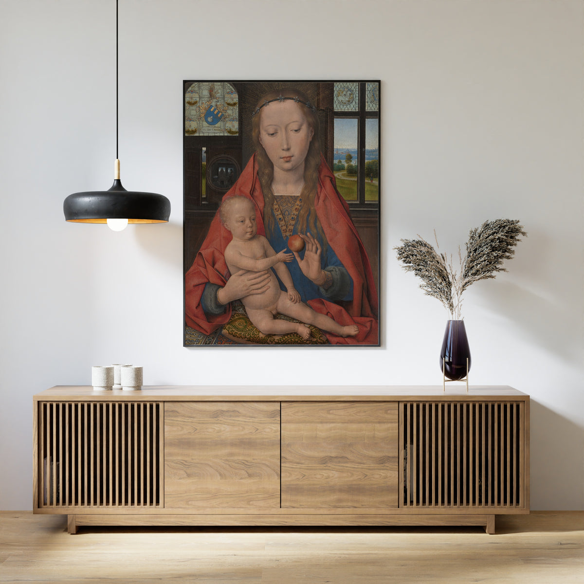 Framed art print of Virgin Mary with the Child Jesus by Hans Memling, above a slatted wood sideboard