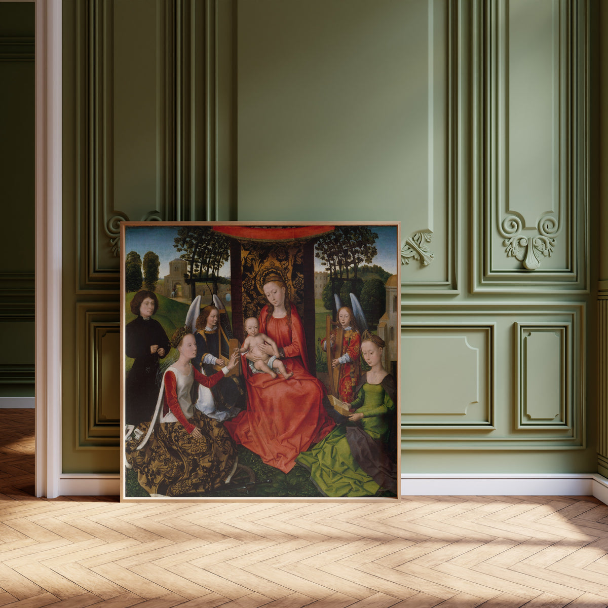 Framed art print of Virgin and Child with Saints Catherine of Alexandria and… by Hans Memling, leaning against olive-green panelling on a herringbone floor