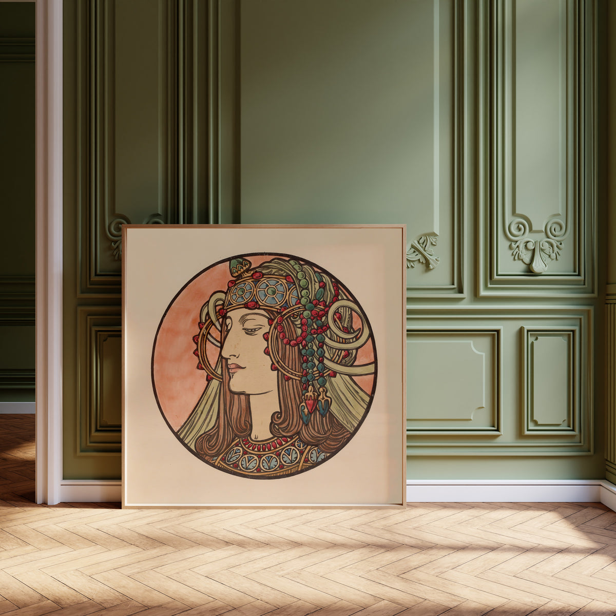 Framed art print of Vitrail pour la façade de la boutique Fouquet (jewelled… by Alphonse Mucha, leaning against olive-green panelling on a herringbone floor