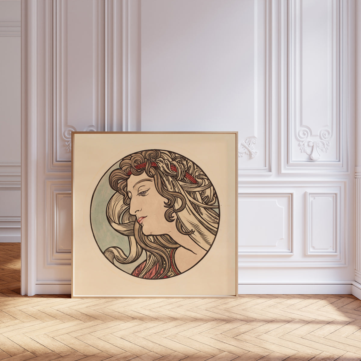 Framed art print of Vitrail pour la façade de la boutique Fouquet (red headband) by Alphonse Mucha, leaning against pale pink panelling on a herringbone floor