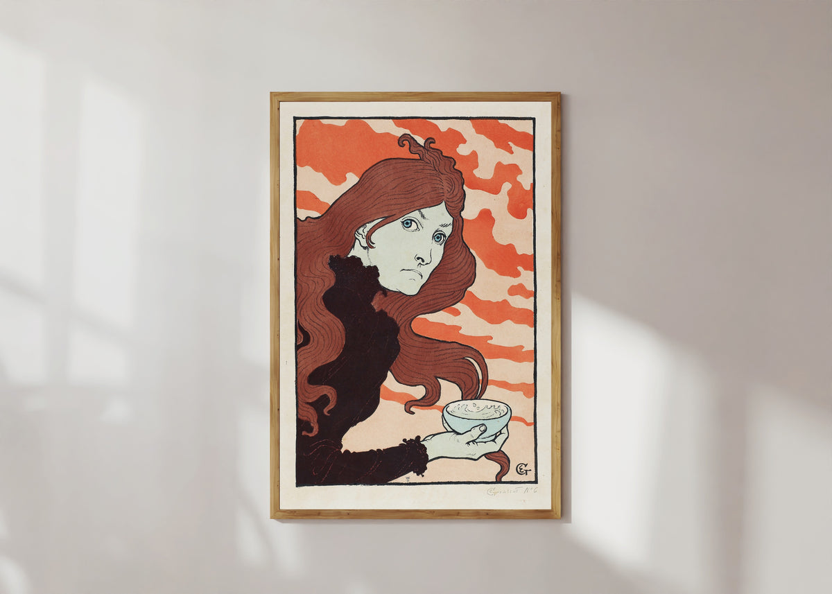 Framed art print of Vitrioleuse (The Acid Thrower) by Eugène Grasset, in a light wood frame on a sunlit white wall