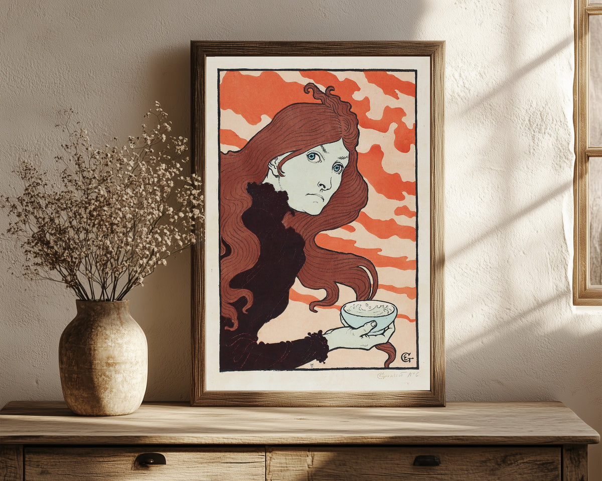 Framed art print of Vitrioleuse (The Acid Thrower) by Eugène Grasset, in a dark wood frame leaning on a rustic console beside dried flowers