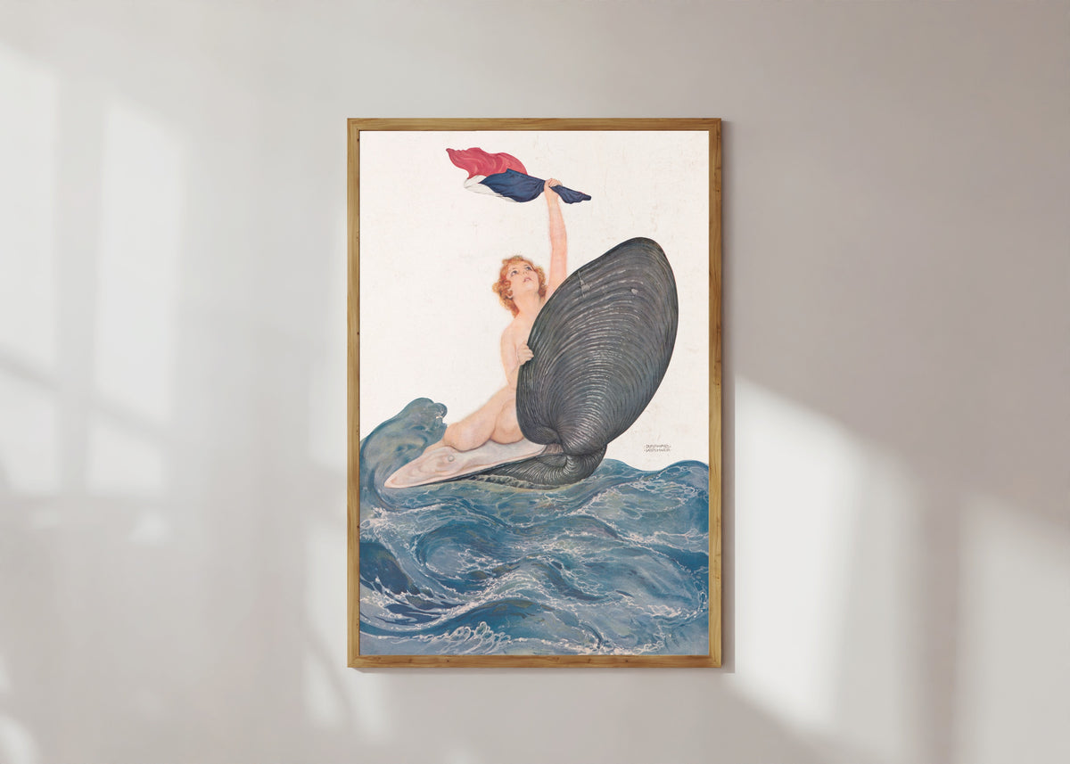 Framed art print of Vive la France by Raphael Kirchner, in a light wood frame on a sunlit white wall