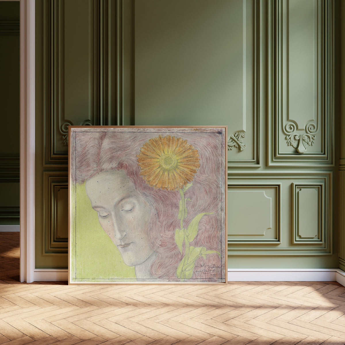 Framed art print of Vrouwenkop met rossig haar en Chrysant by Jan Toorop, leaning against olive-green panelling on a herringbone floor