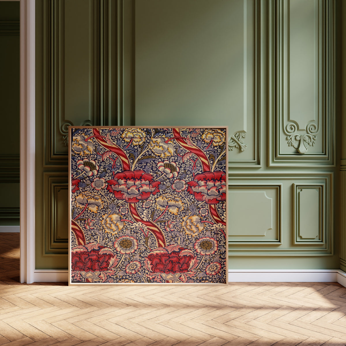 Framed art print of Wandle by William Morris, leaning against olive-green panelling on a herringbone floor