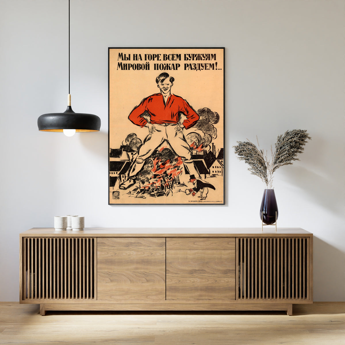 Framed art print of We Will Fan a World Fire to the Grief of All Bourgeois by Alexander Zelensky, above a slatted wood sideboard