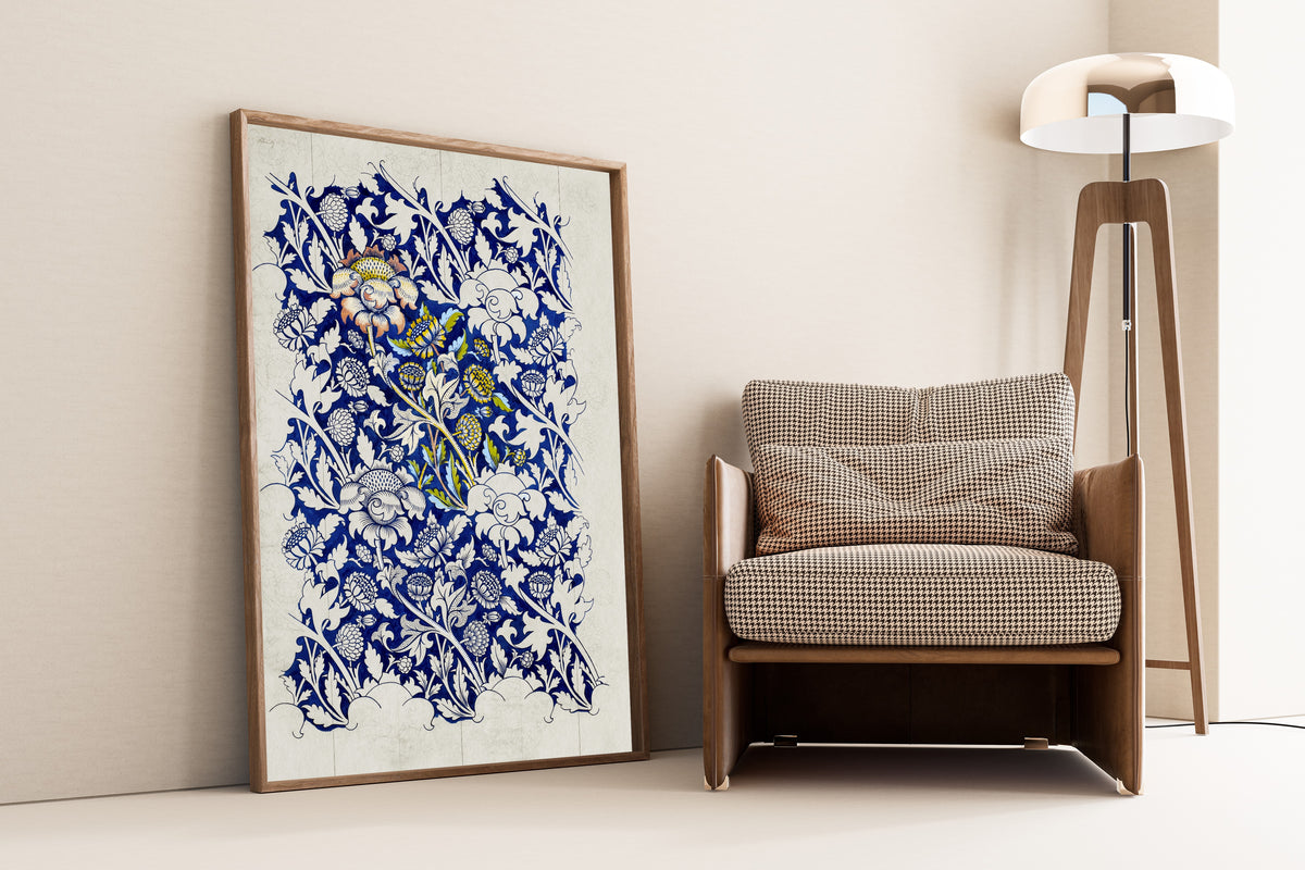 Framed art print of Wey (Design Drawing) by William Morris, leaning against a wall beside an armchair and a floor lamp