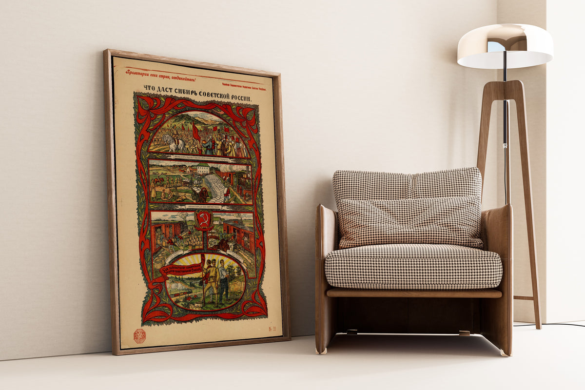 Framed art print of What Siberia Will Give Soviet Russia by Vasily Spasskiy, leaning against a wall beside an armchair and a floor lamp