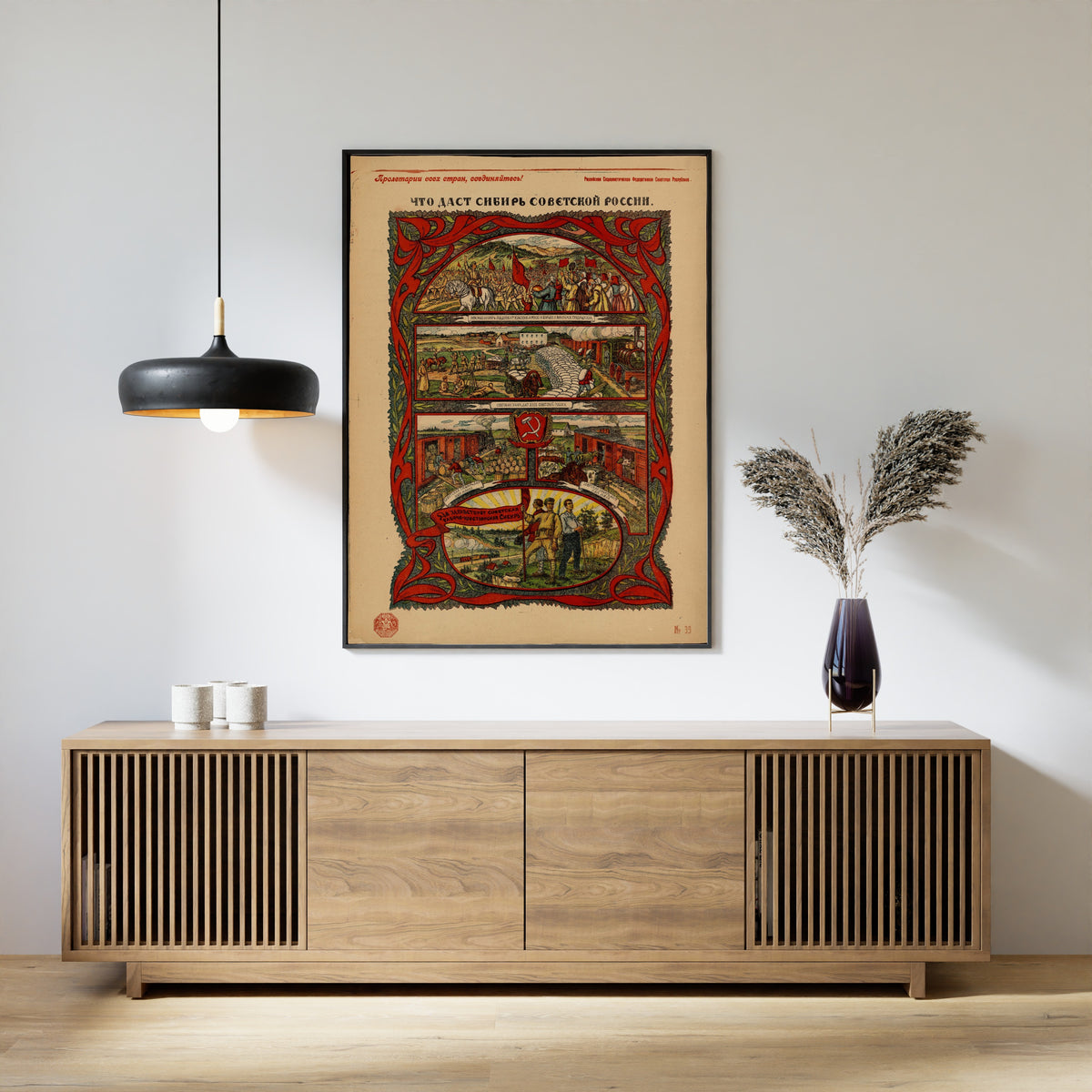 Framed art print of What Siberia Will Give Soviet Russia by Vasily Spasskiy, above a slatted wood sideboard