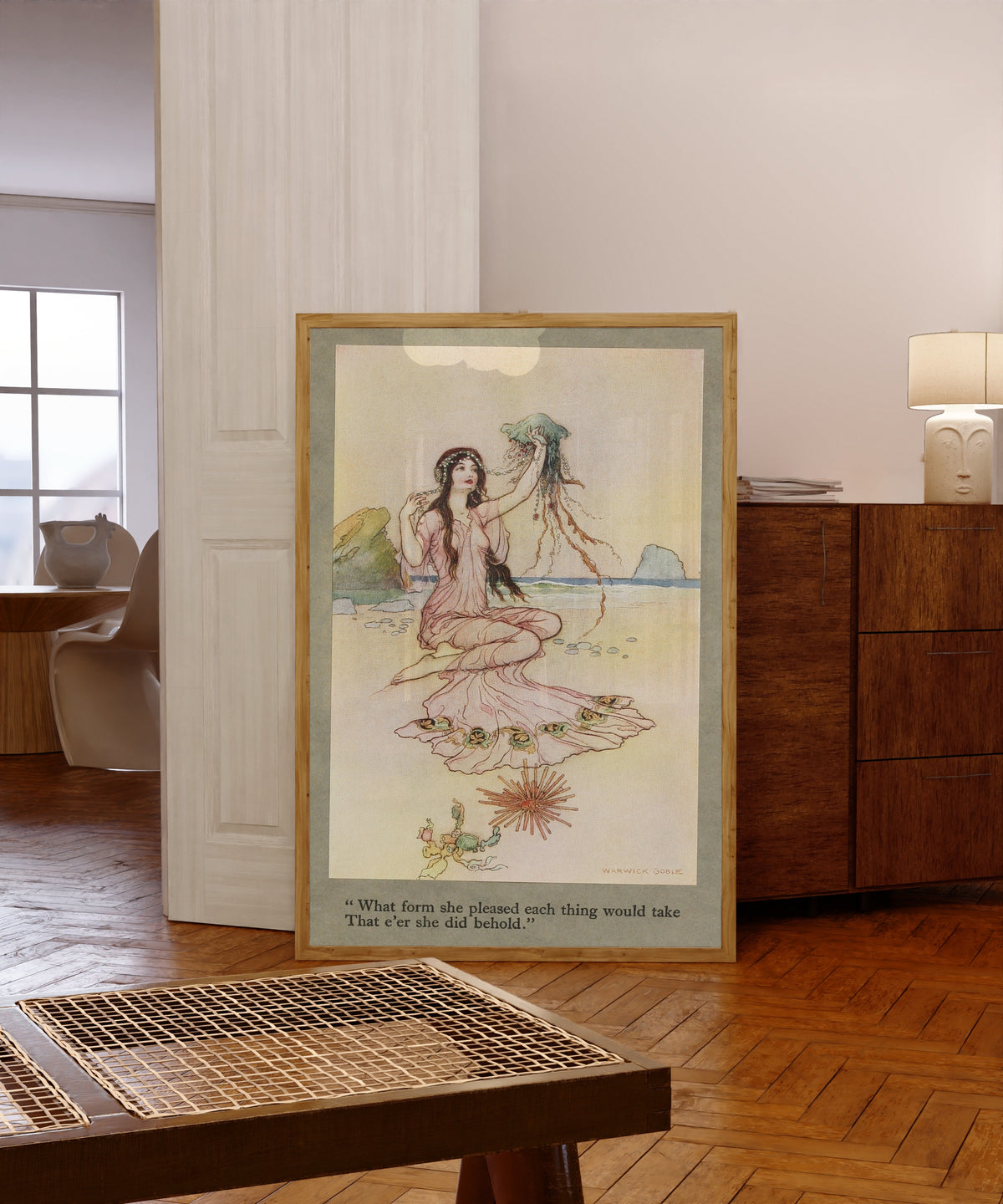 Framed art print of What form she pleased each thing would take that e’er… by Warwick Goble, in a light wood frame leaning in a warm room with a parquet floor