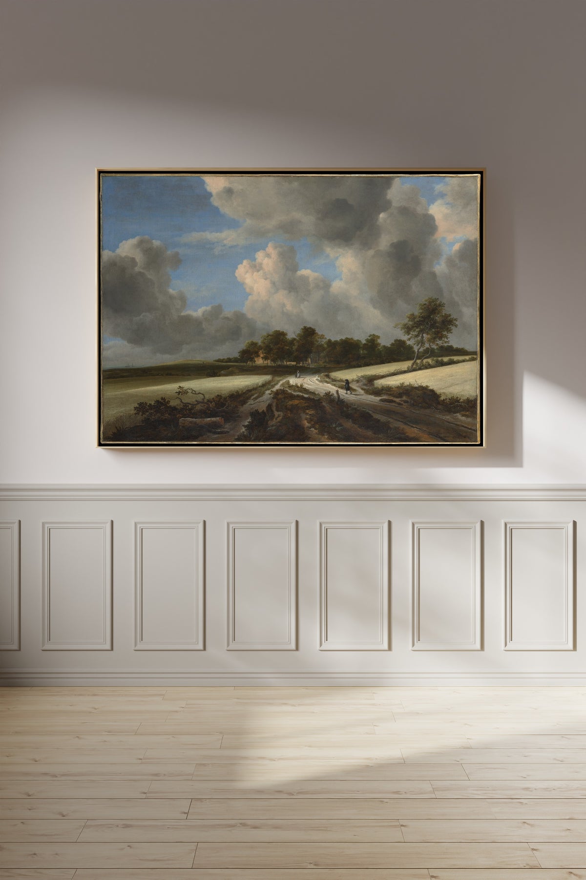 Wheat Fields by Jacob van Ruisdael — framed on a panelled wall in afternoon light