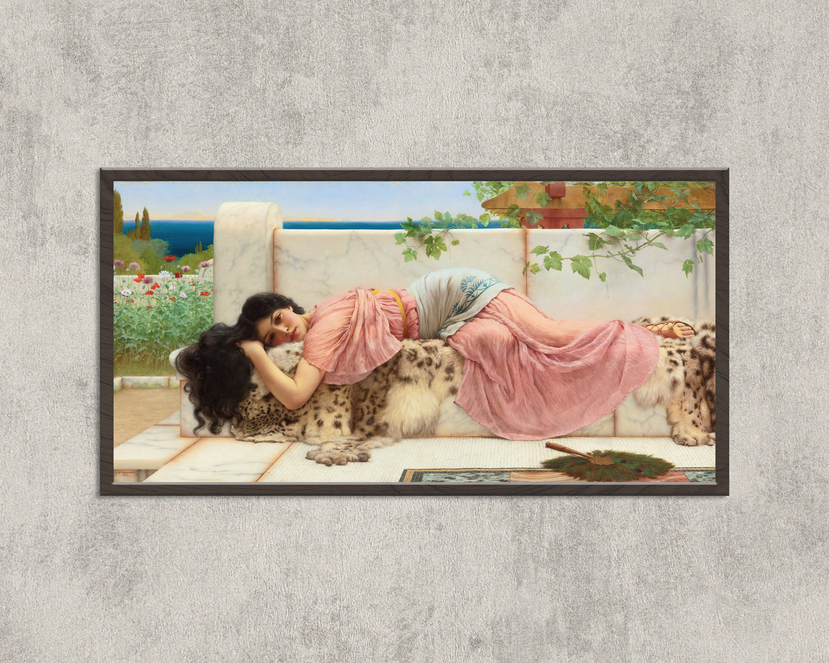 Framed art print of When the Heart is Young by John William Godward, in a wide black frame on a concrete wall