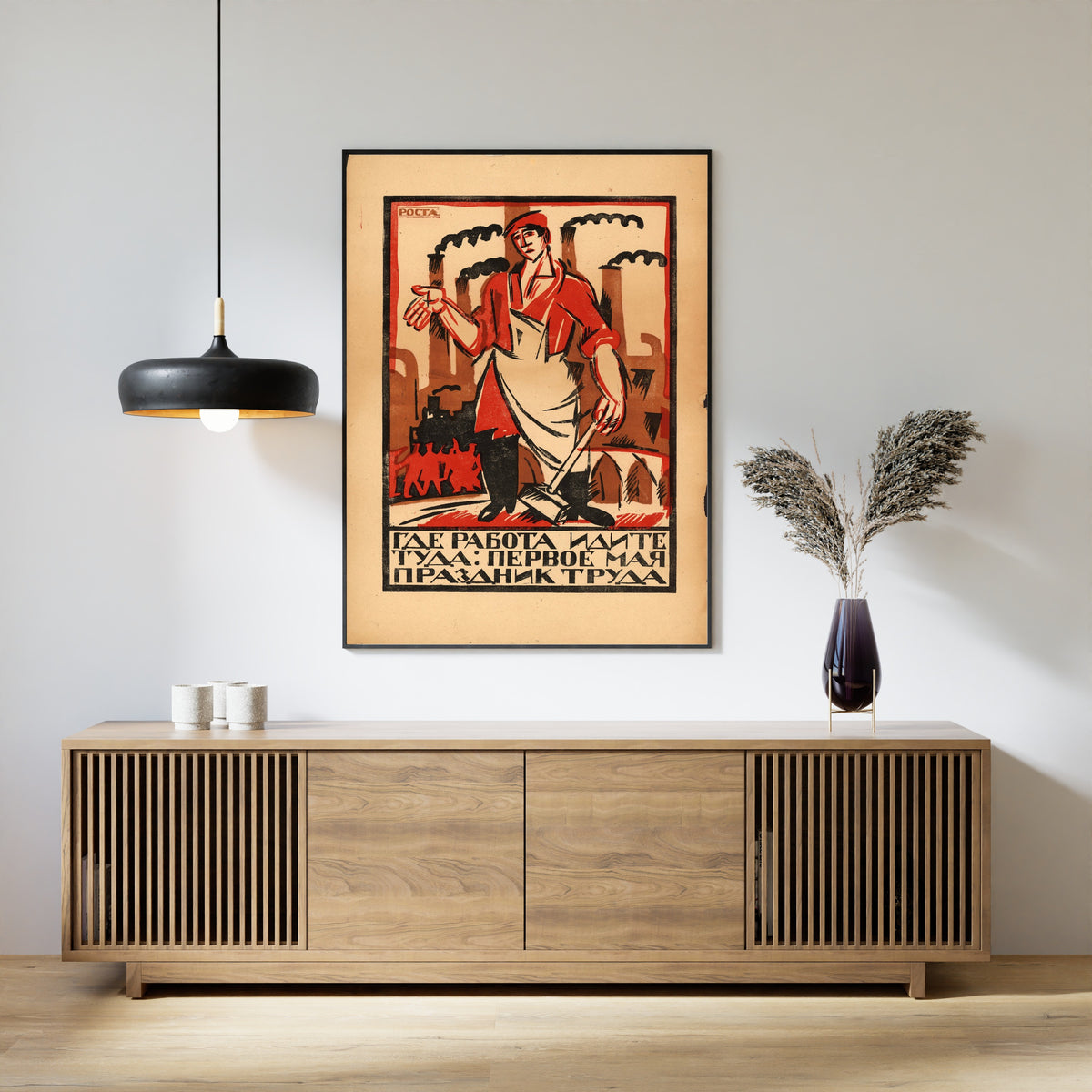 Framed art print of Where There Is Work, Go There: May Day Is the Holiday of Labour by Ivan Malyutin, above a slatted wood sideboard