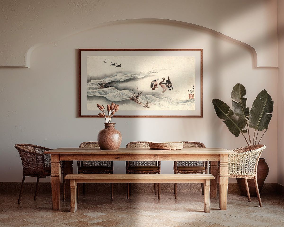 Framed art print of Wild Geese and Water by Katsushika Hokusai, above a wooden dining table