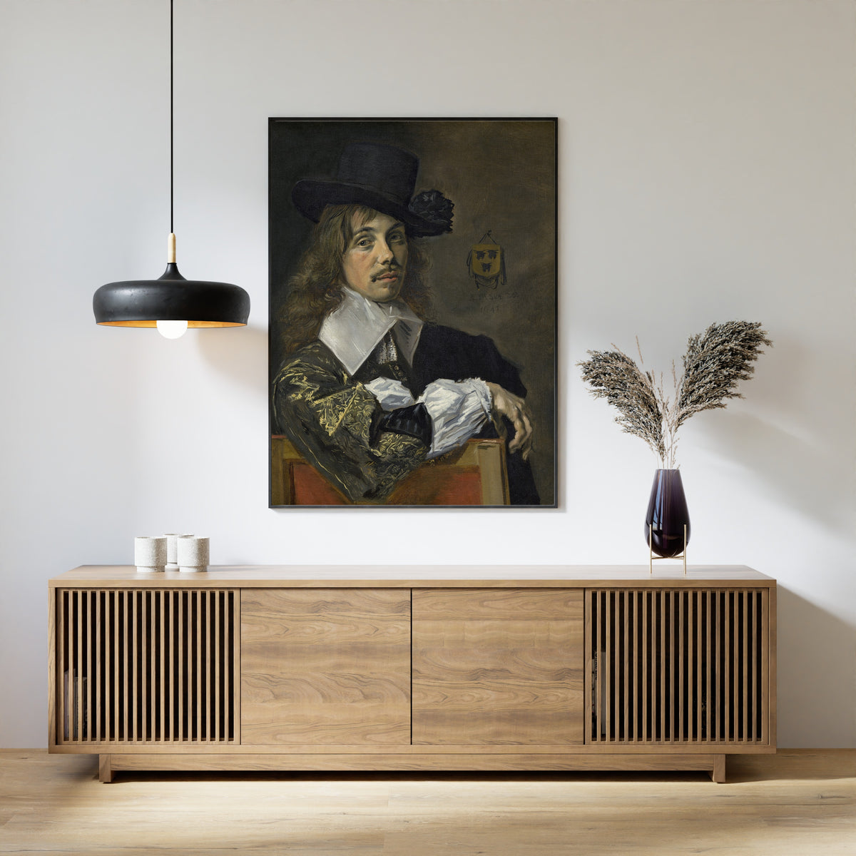 Framed art print of Willem Coymans by Frans Hals, above a slatted wood sideboard