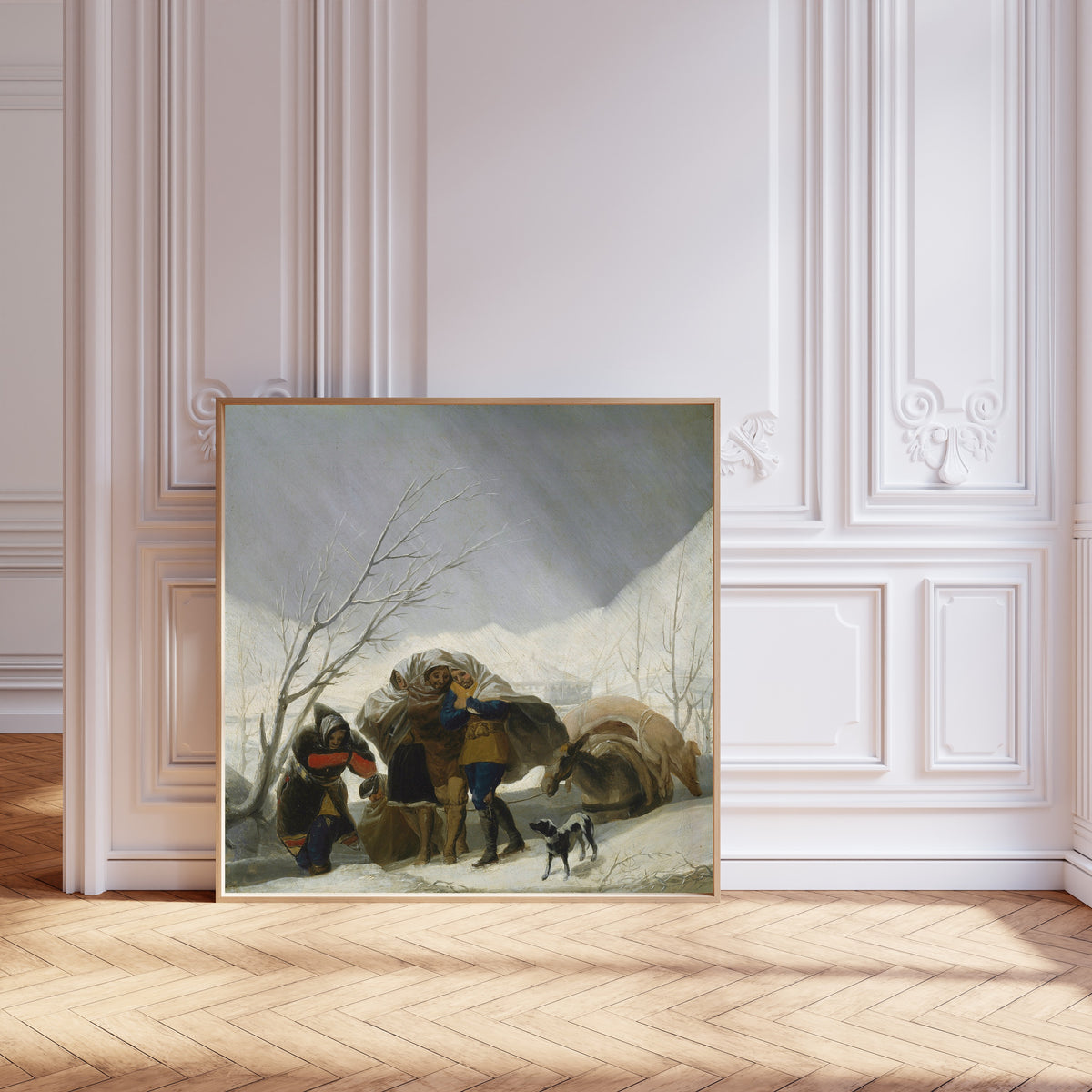 Framed art print of Winter Scene by Francisco de Goya, leaning against pale pink panelling on a herringbone floor