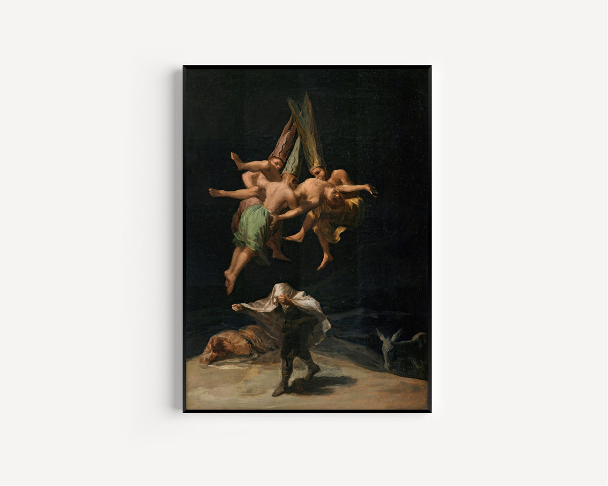 Framed art print of Witches' Flight by Francisco de Goya, in a slim black frame on a plain white wall