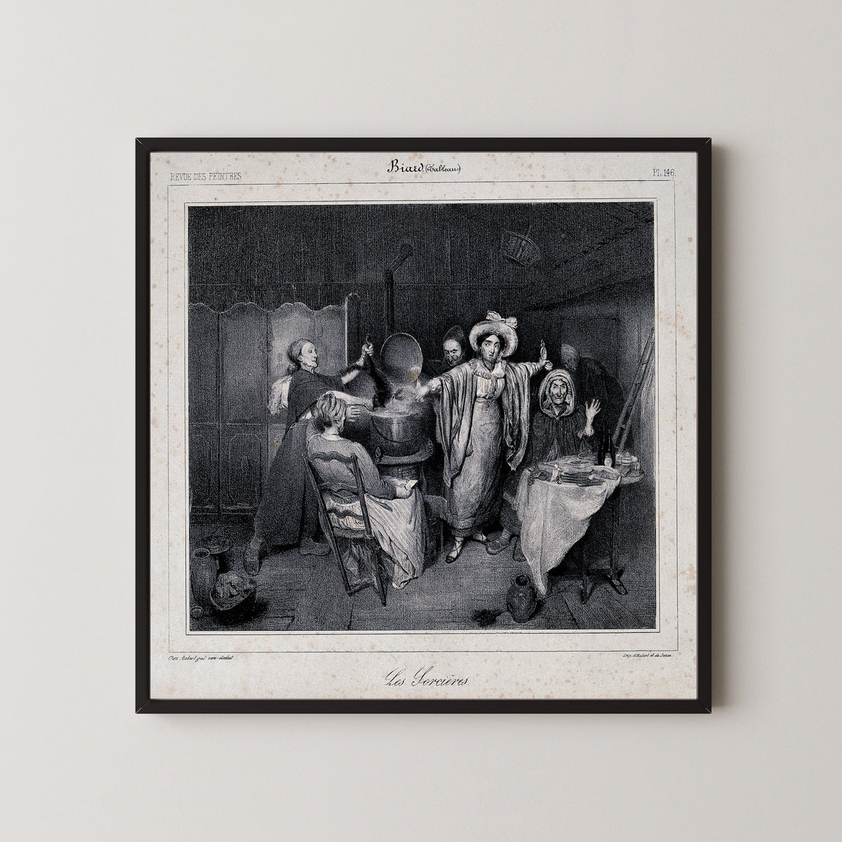Framed art print of Witches Putting a Creature in a Boiling Cauldron by Unknown artist, in a black frame on a pale wall