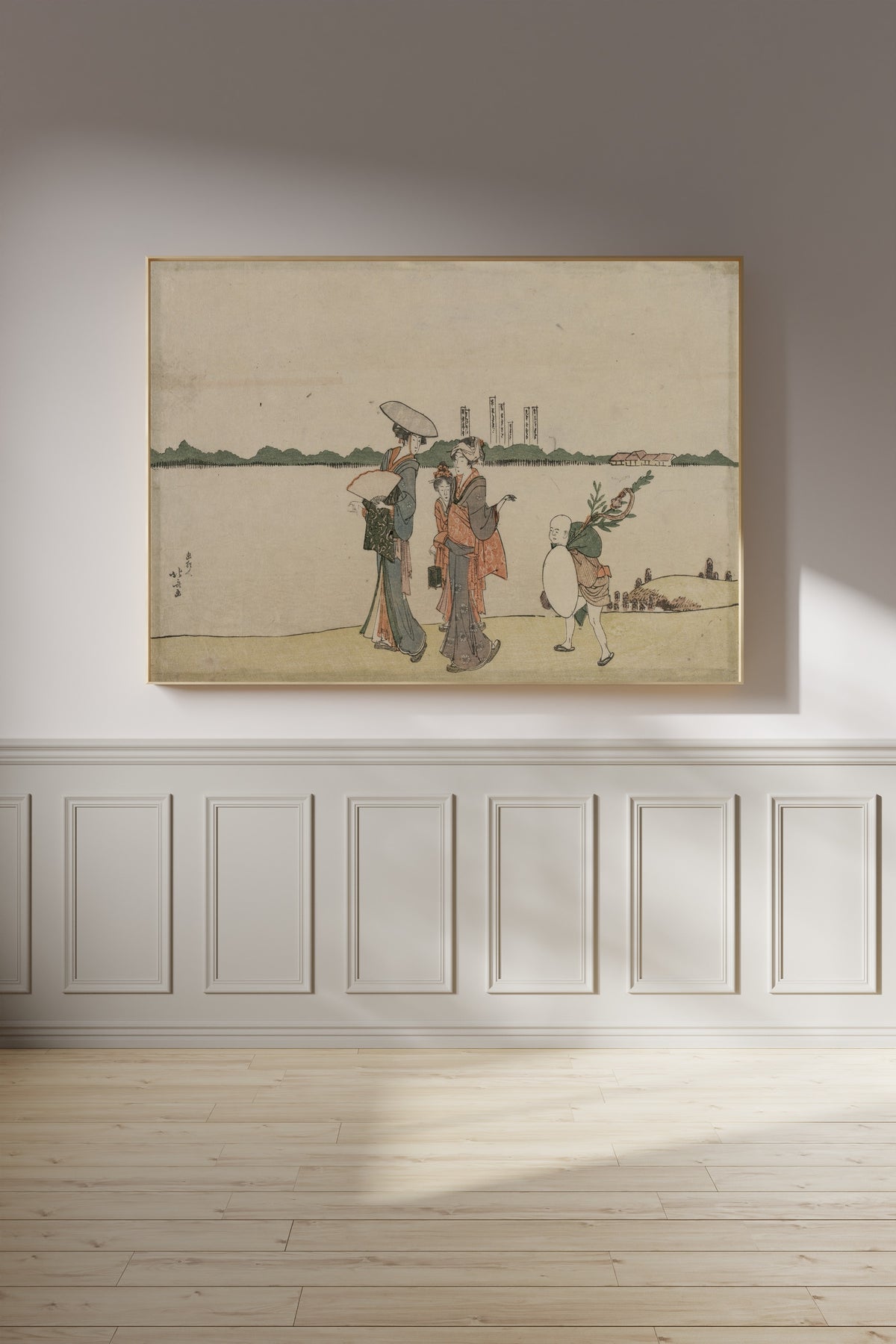 Framed art print of Women and Children Walking Along the Sumida River by Katsushika Hokusai, on a panelled wall in afternoon light
