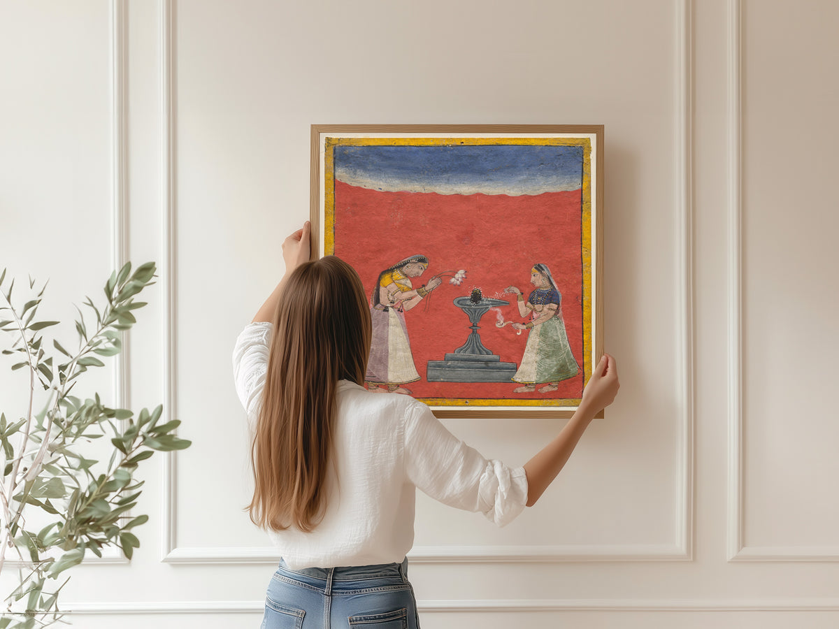Framed art print of Women worshiping a Shiva linga: Devagandhari Ragini of Hindol Raga by Pahari school, hung on a panelled wall