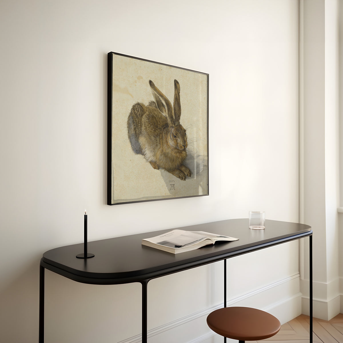 Framed art print of Young Hare by Albrecht Dürer, above a slim black console table