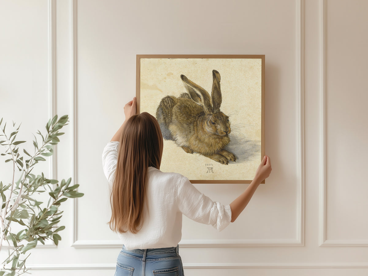 Framed art print of Young Hare by Albrecht Dürer, hung on a panelled wall