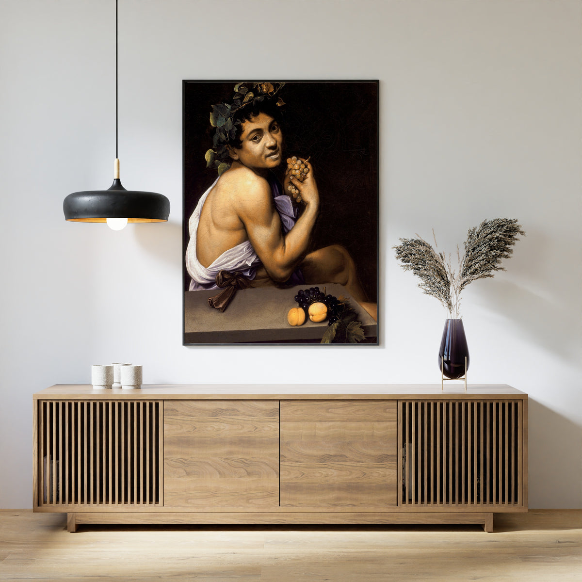 Framed art print of Young Sick Bacchus by Caravaggio, above a slatted wood sideboard