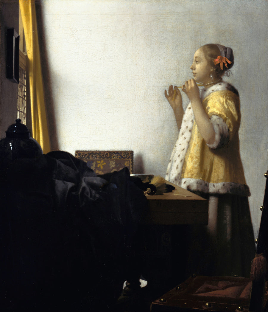 Johannes Vermeer — Young Woman with a Pearl Necklace | Fine Art Print shown to scale on a wall above a sofa