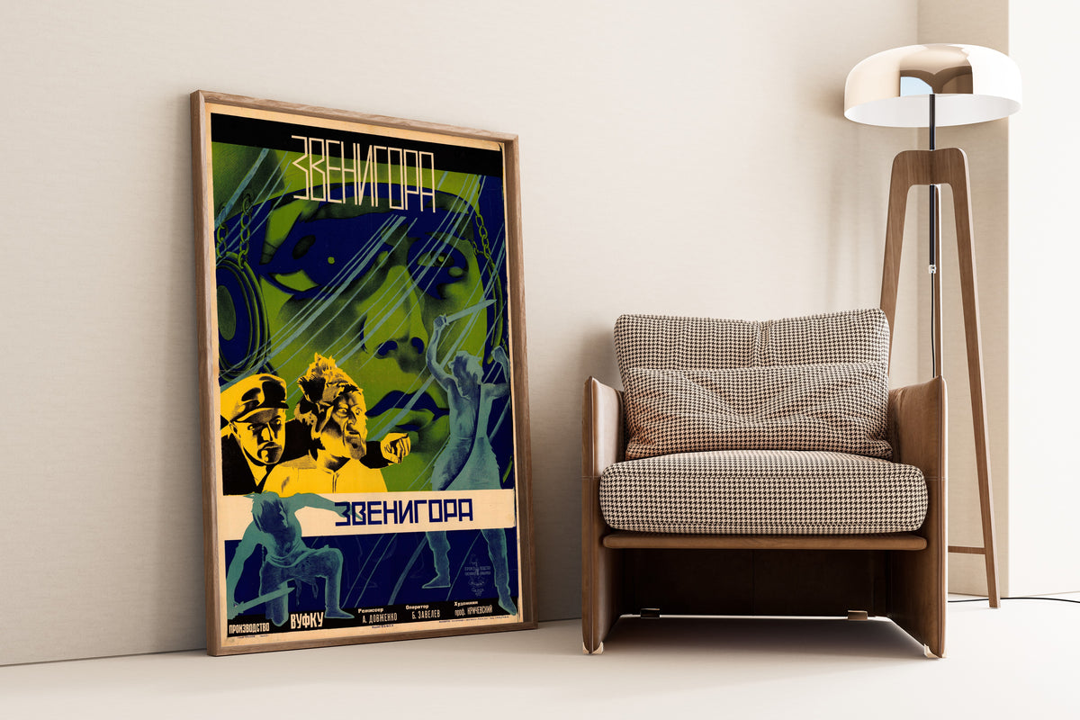 Framed art print of Zvenigora by Leonid Voronov and Mikhail Evstafiev, leaning against a wall beside an armchair and a floor lamp