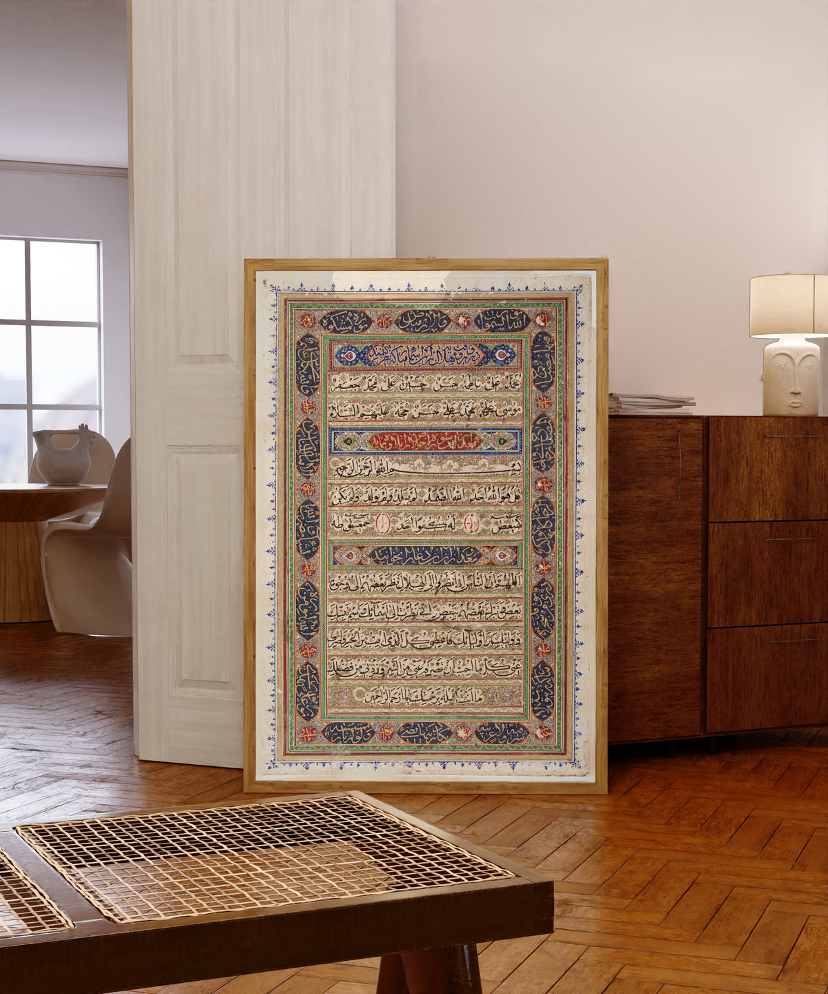 Framed art print of Page from a Manuscript of the Qur'an (end page), in a light wood frame leaning in a warm room with a parquet floor