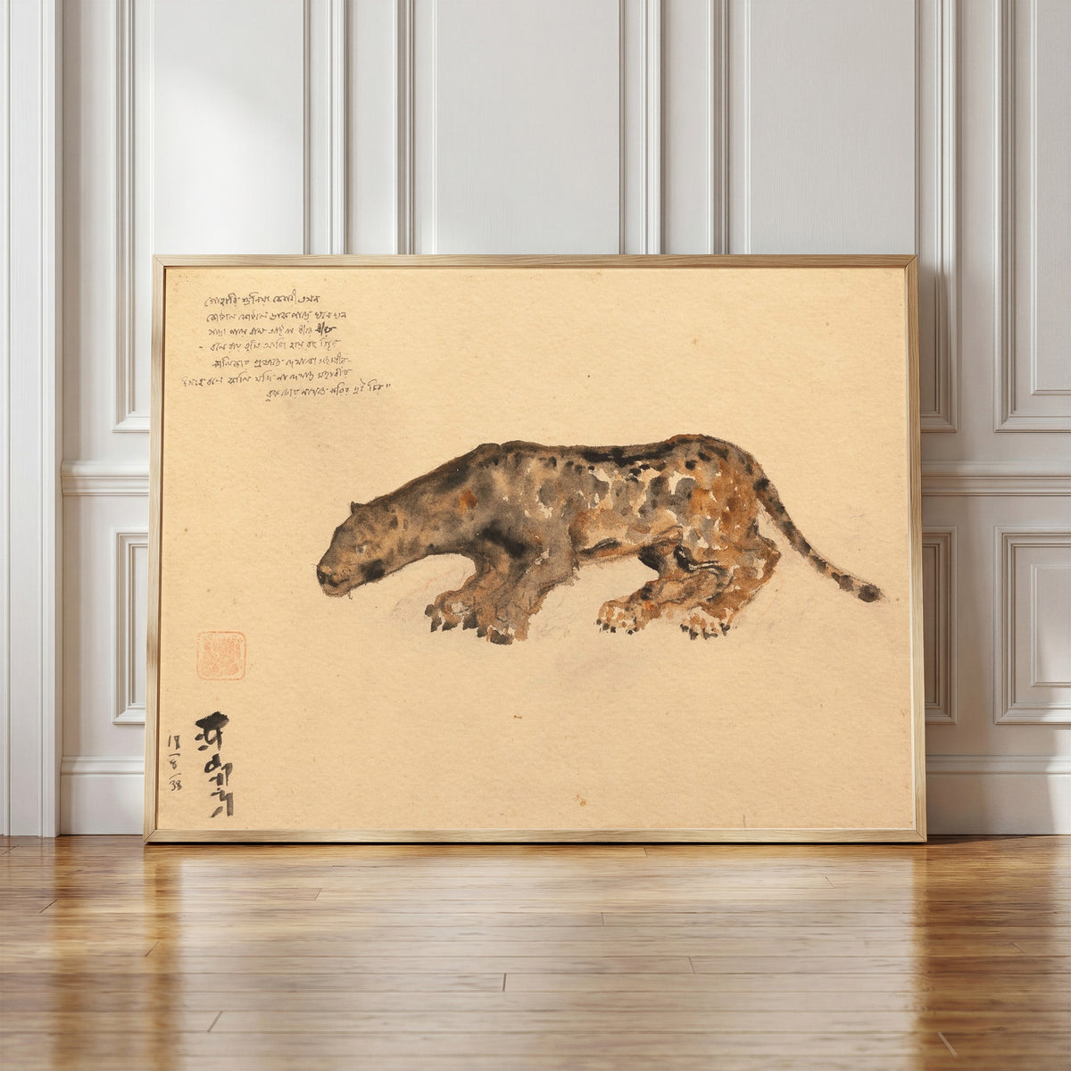 Framed art print of Bagh Raja (The Tiger King) by Abanindranath Tagore, in a light wood frame leaning against a panelled white wall