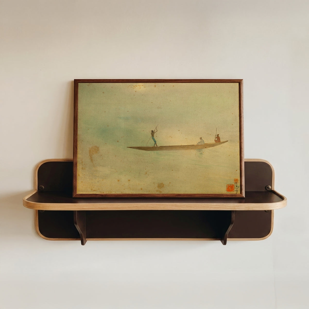 Framed art print of Village Music by Abanindranath Tagore, in a dark wood frame resting on a wall shelf