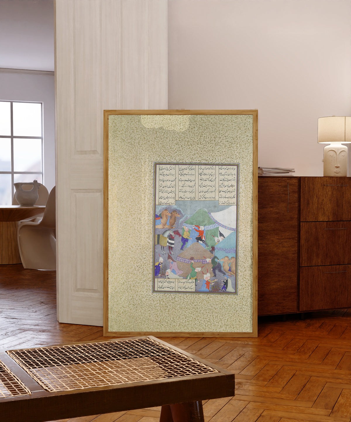 Framed art print of Shahnama of Shah Tahmasp: Isfandiyar's… by Abd al-Vahhab (attributed), in a light wood frame leaning in a warm room with a parquet floor