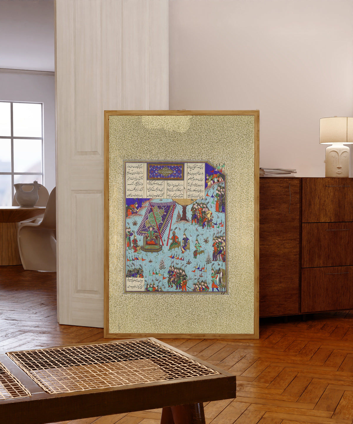 Framed art print of Shahnama of Shah Tahmasp: Shangul Stirs… by Abd al-Vahhab (attributed), in a light wood frame leaning in a warm room with a parquet floor