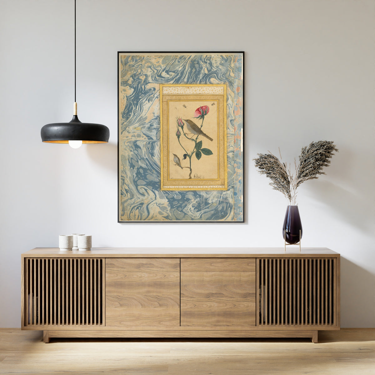 Two Nightingales in a Rose Bush by Abdullah Bukhari — framed above a slatted wood sideboard