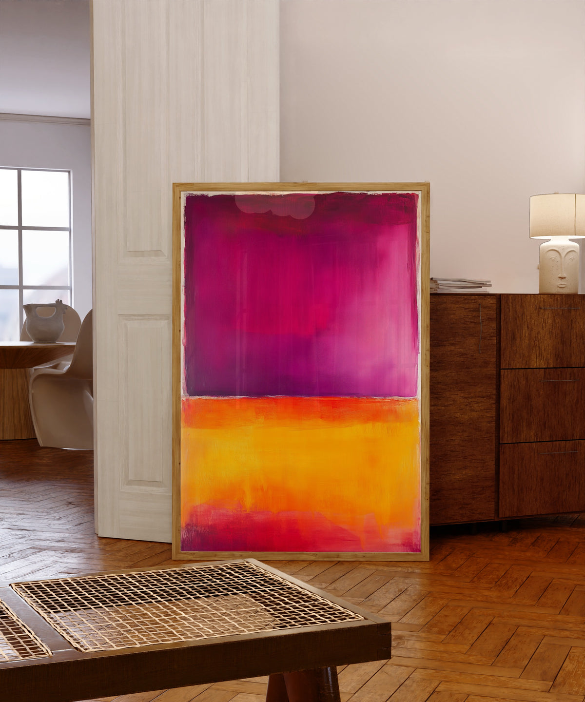Framed art print of Orange and Purple (Colour Field) by After Mark Rothko, in a light wood frame leaning in a warm room with a parquet floor