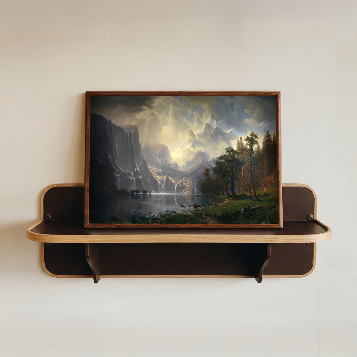 Framed art print of Among the Sierra Nevada, California by Albert Bierstadt, in a dark wood frame resting on a wall shelf