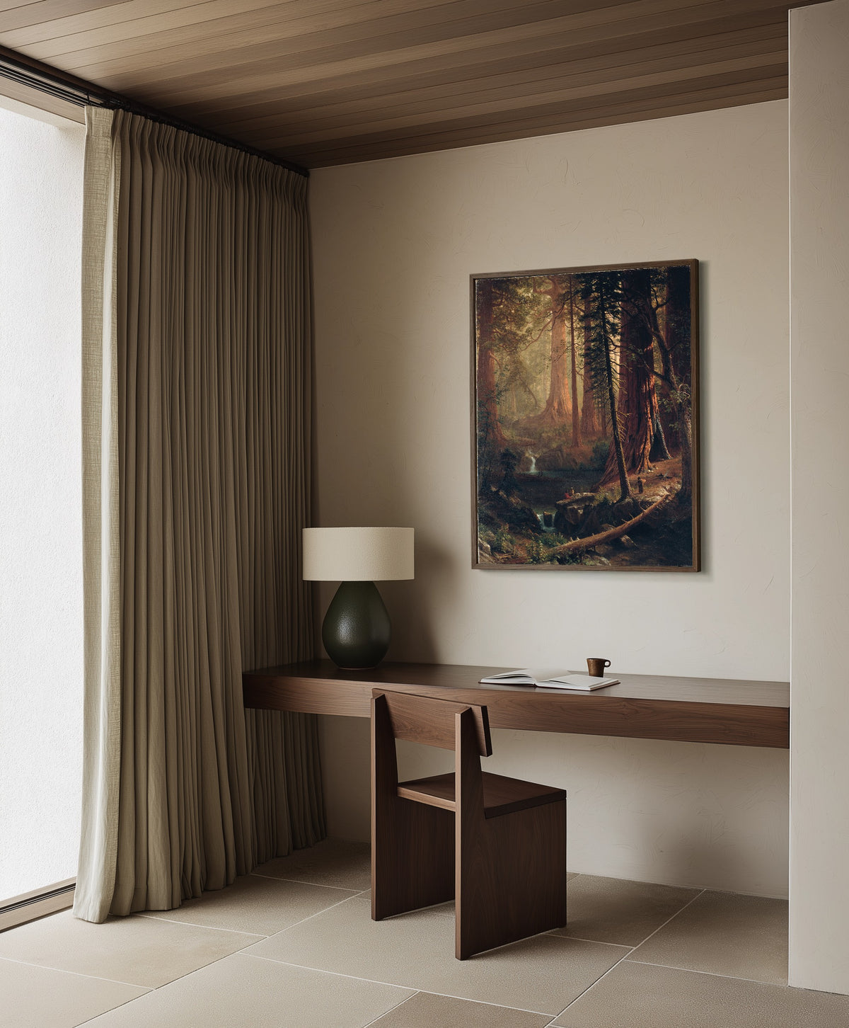 Framed art print of Giant Redwood Trees of California by Albert Bierstadt, in a dark wood frame on a plaster wall above a walnut desk
