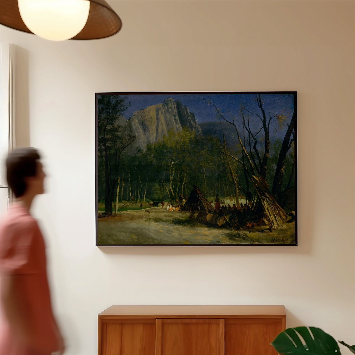 Framed art print of Indians in Council, California by Albert Bierstadt, in a slim black frame on a warm wall in a sunlit room
