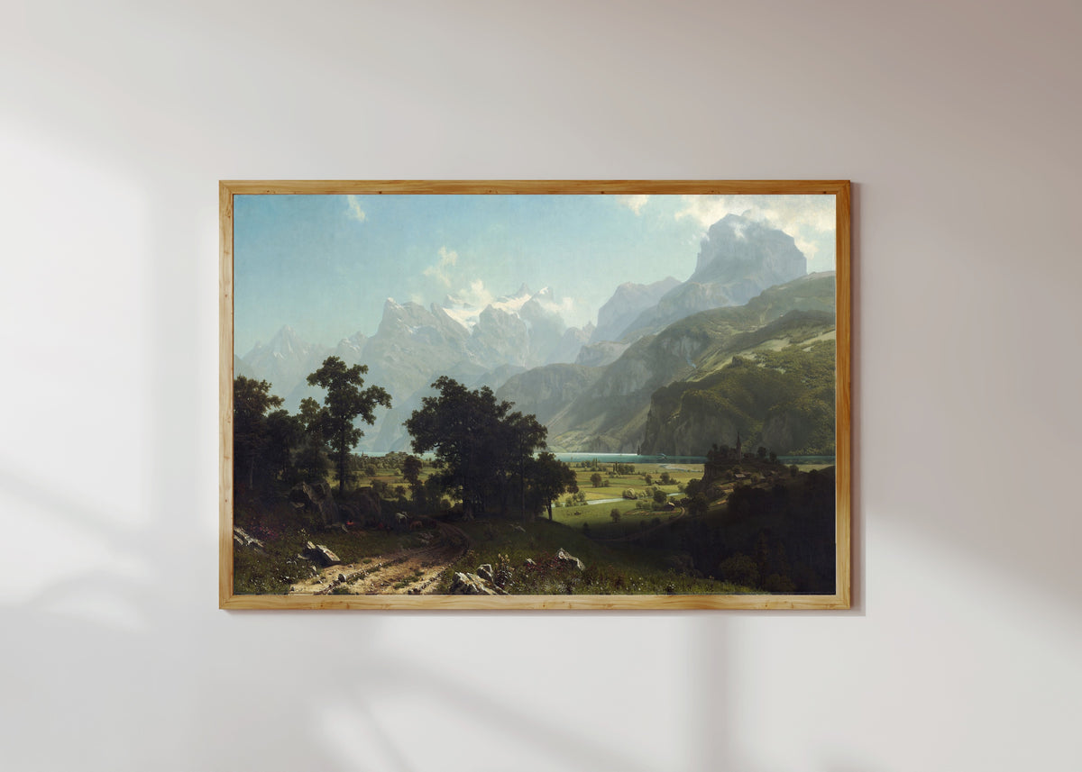 Framed art print of Lake Lucerne by Albert Bierstadt, in a light wood frame on a sunlit white wall