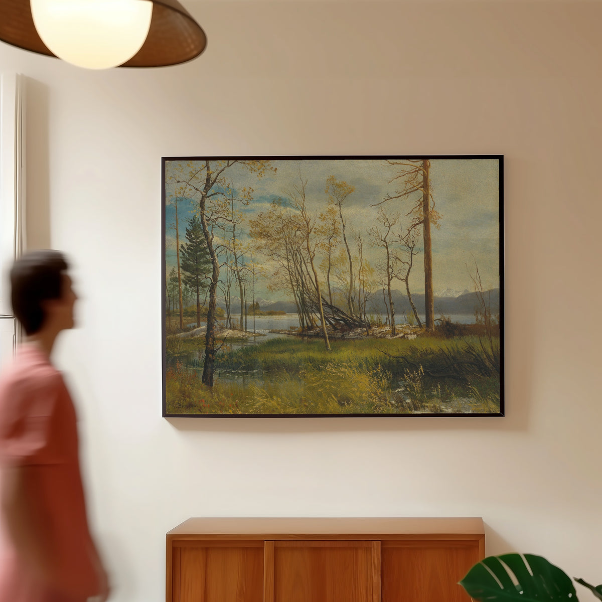 Framed art print of Lake Tahoe by Albert Bierstadt, in a slim black frame on a warm wall in a sunlit room