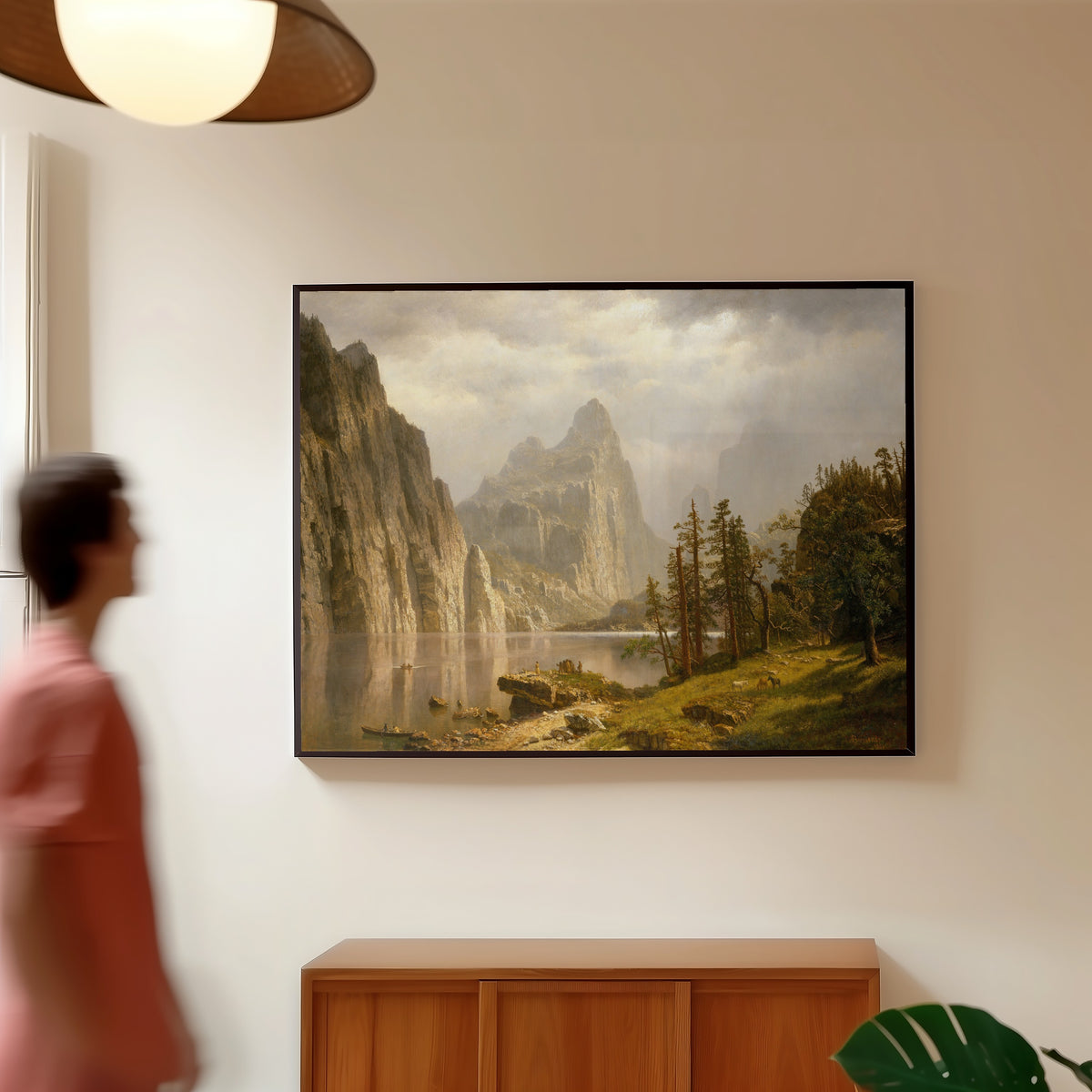 Framed art print of Merced River, Yosemite Valley by Albert Bierstadt, in a slim black frame on a warm wall in a sunlit room