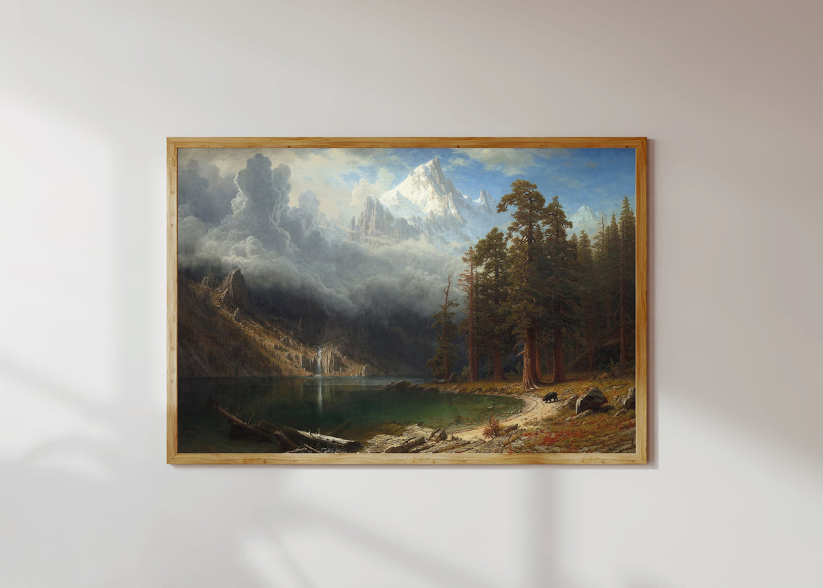 Framed art print of Mount Corcoran by Albert Bierstadt, in a light wood frame on a sunlit white wall