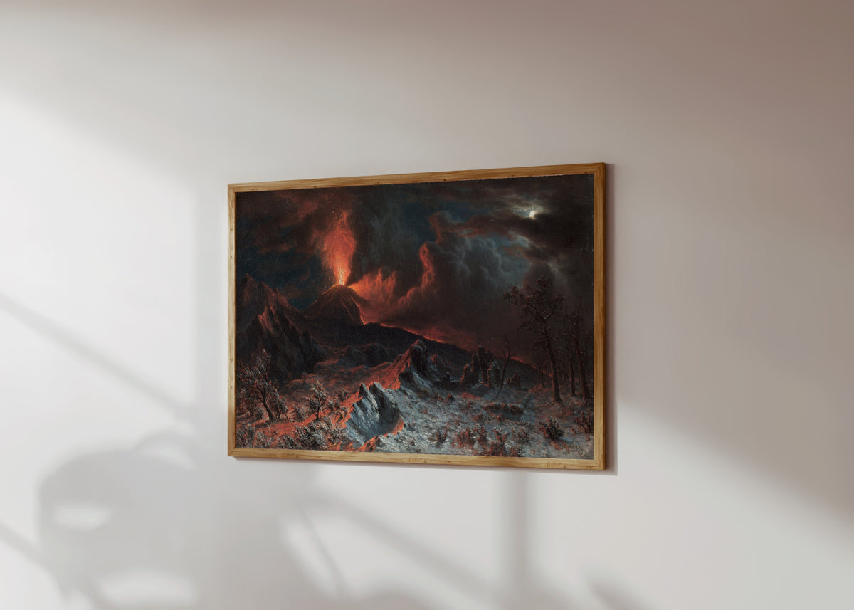 Framed art print of Mount Vesuvius at Midnight by Albert Bierstadt, in a light wood frame on a sunlit white wall, seen at a slight angle