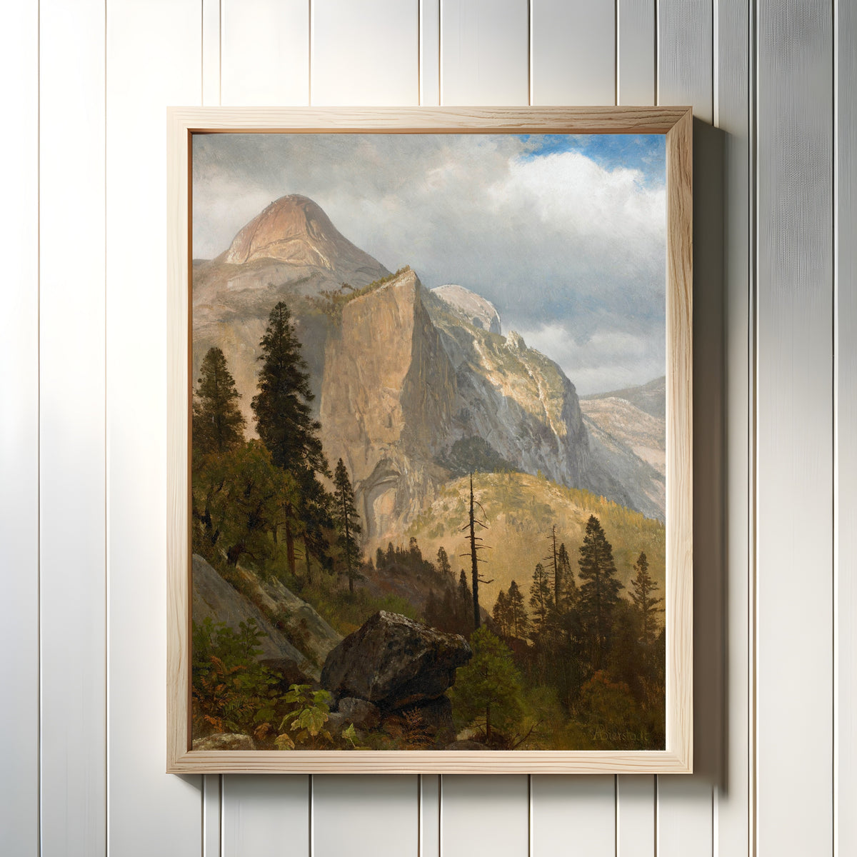 Framed art print of North Dome, Yosemite Valley by Albert Bierstadt, in a light wood frame on a white panelled wall