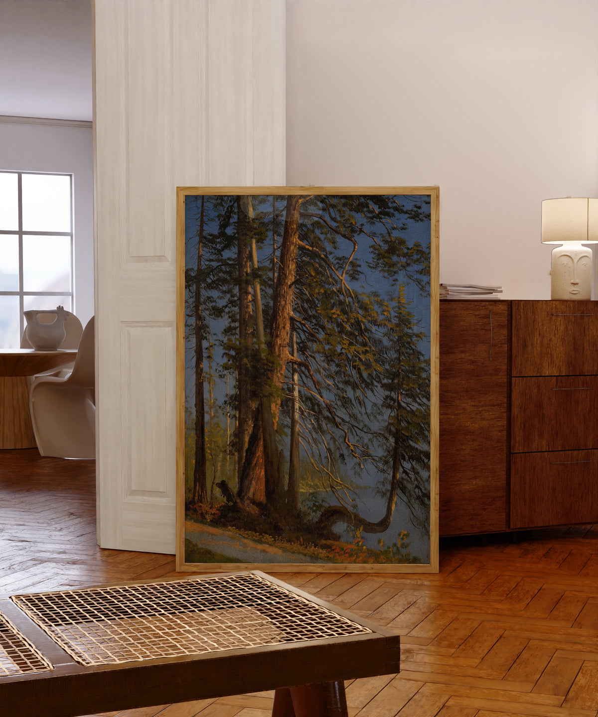 Framed art print of Park at Vancouver by Albert Bierstadt, in a light wood frame leaning in a warm room with a parquet floor