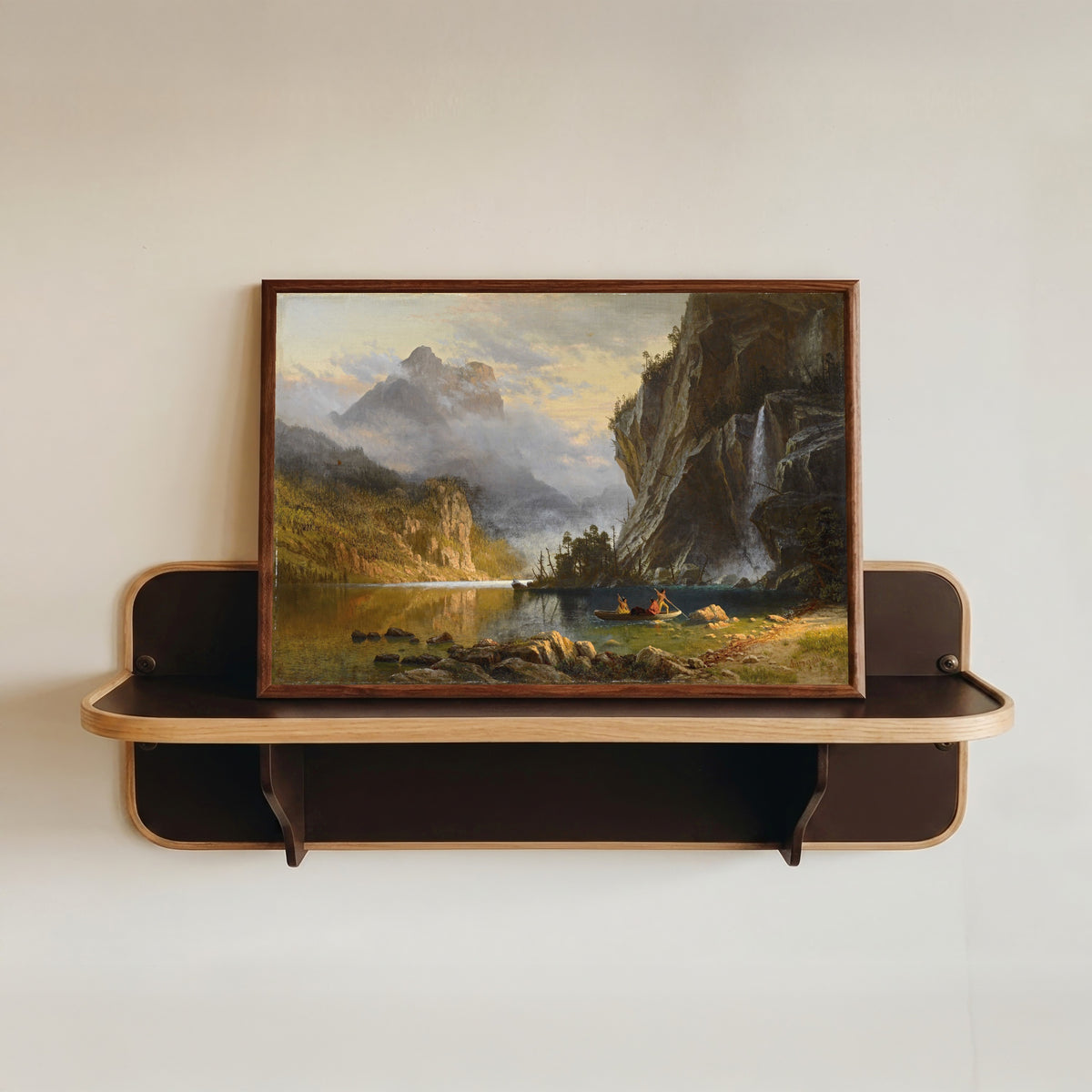 Framed art print of Spear Fishing by Albert Bierstadt, in a dark wood frame resting on a wall shelf