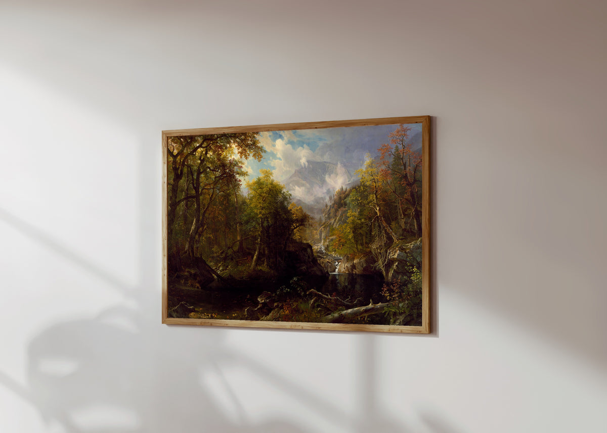 Framed art print of The Emerald Pool by Albert Bierstadt, in a light wood frame on a sunlit white wall, seen at a slight angle