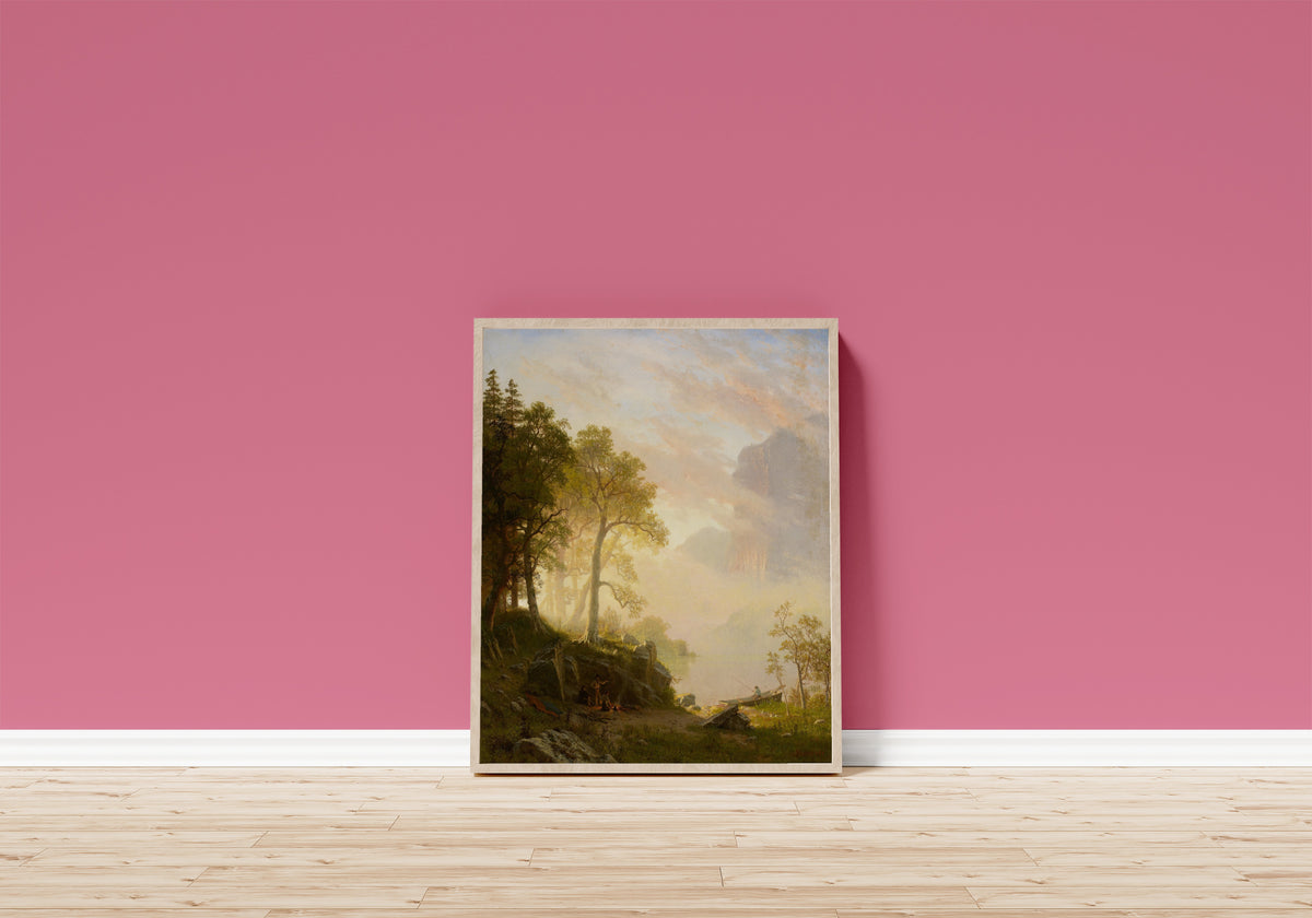 Framed art print of The Merced River in Yosemite by Albert Bierstadt, in a light wood frame leaning on a pink wall above a wooden floor